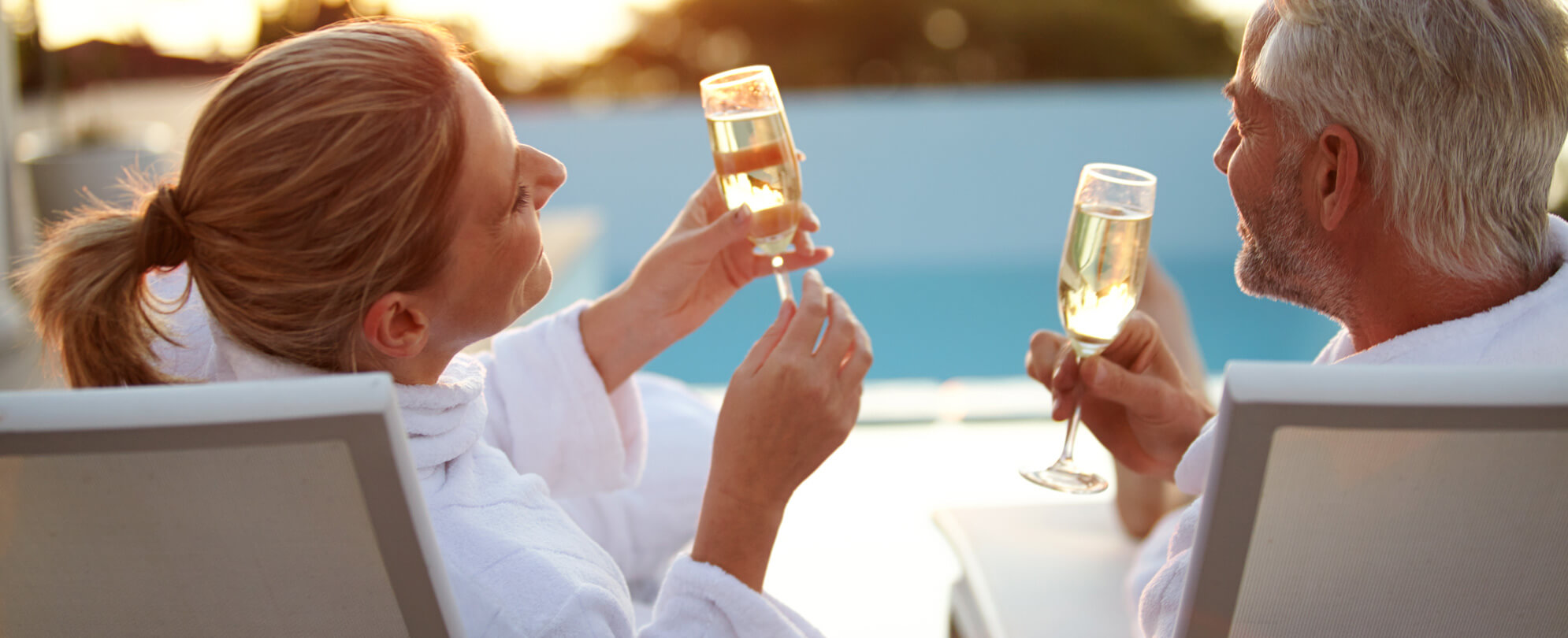 Man and woman in robes drinking champagne