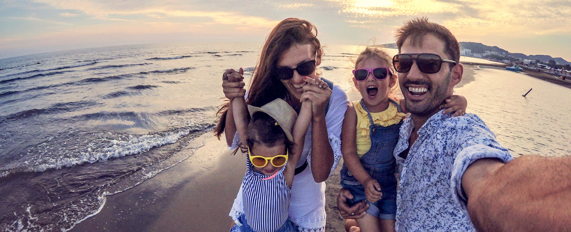Mother and children wearing sunglasses taking a fun family photo together 