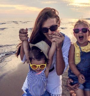 Mother and children wearing sunglasses taking a fun family photo together 