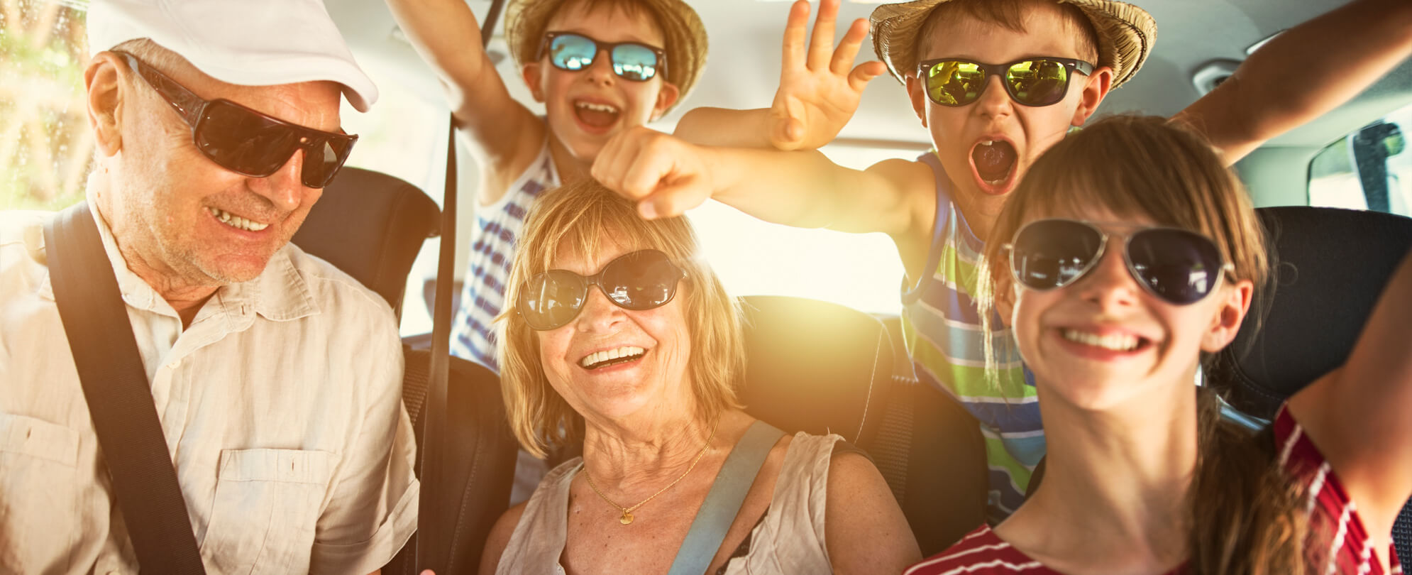 Mother and children wearing sunglasses taking a fun family photo together 