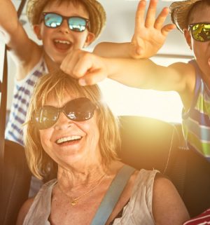 Mother and children wearing sunglasses taking a fun family photo together 