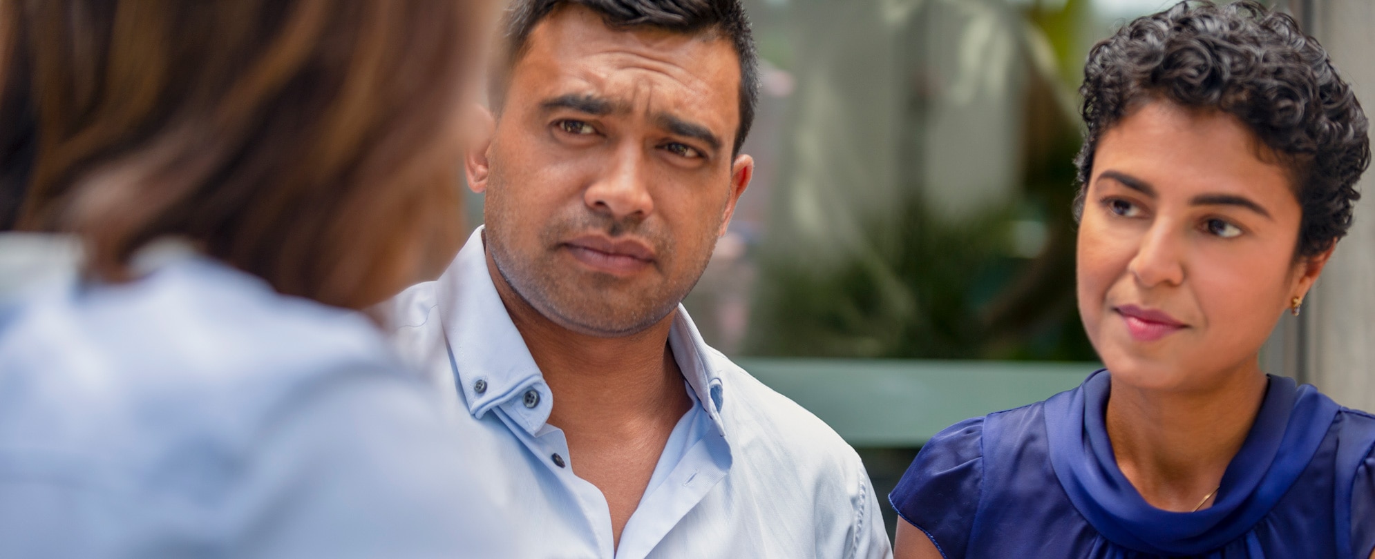 A hispanic couple listening intently