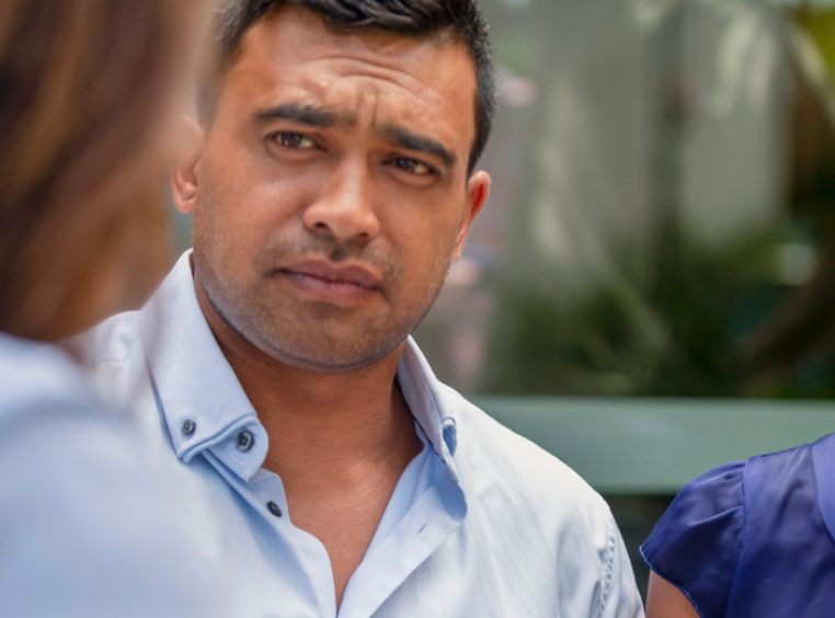 A hispanic couple listening intently