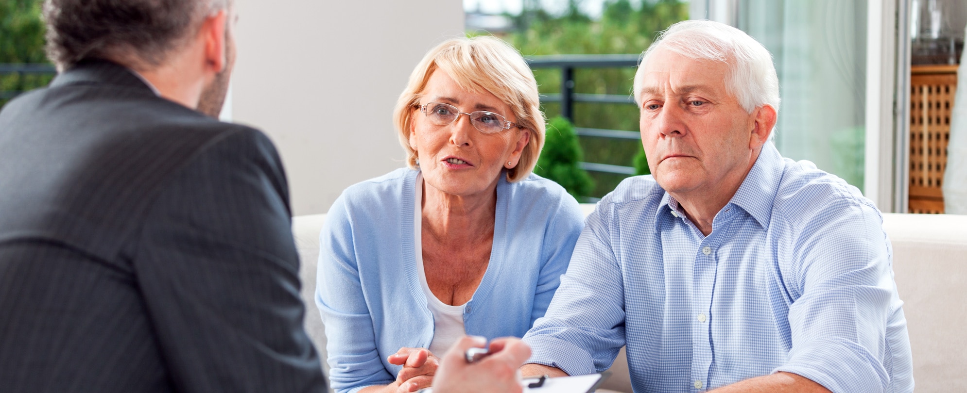 Senior couple talking with financial advisor 