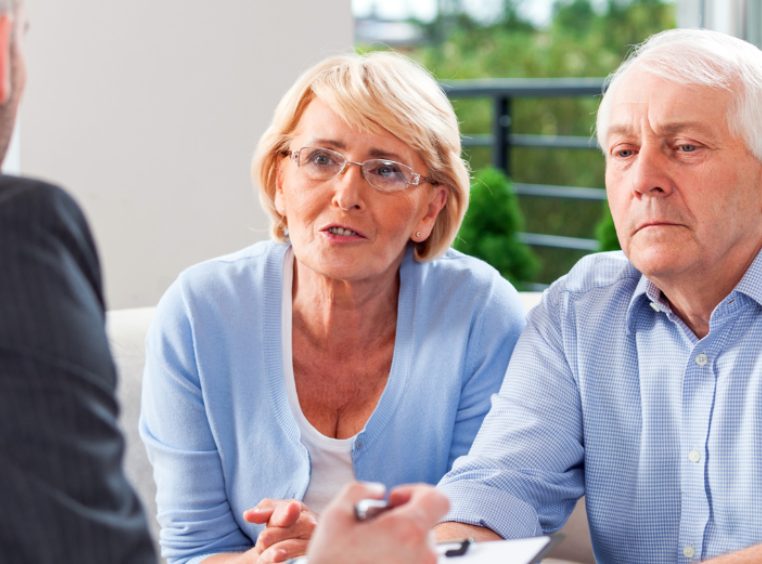 Senior couple talking with financial advisor 