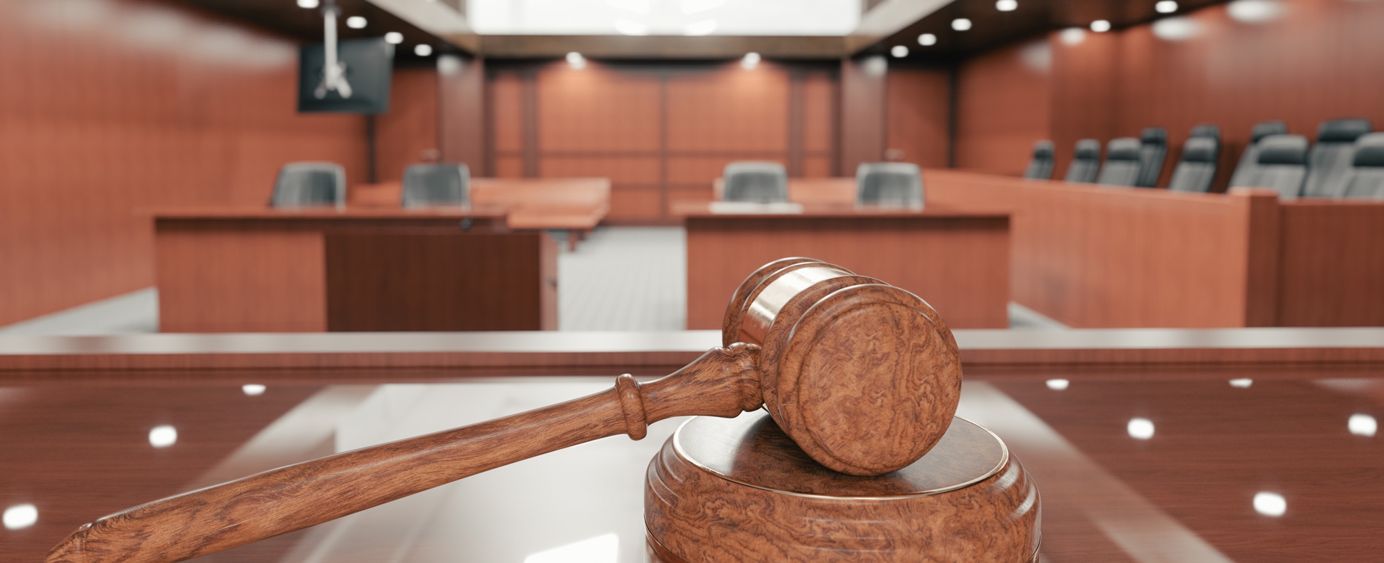 Interior of an empty courtroom with gavel and sounding block on the desk