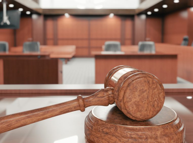 Interior of an empty courtroom with gavel and sounding block on the desk