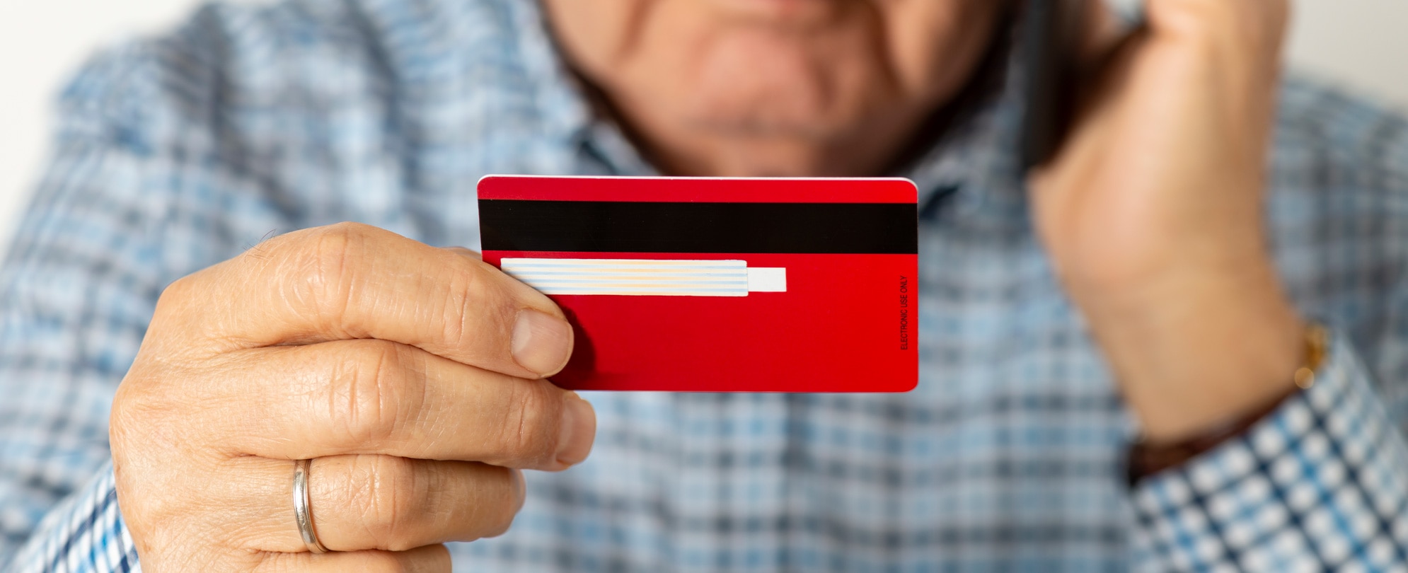 Hands holding a credit card and typing on laptop keyboard 