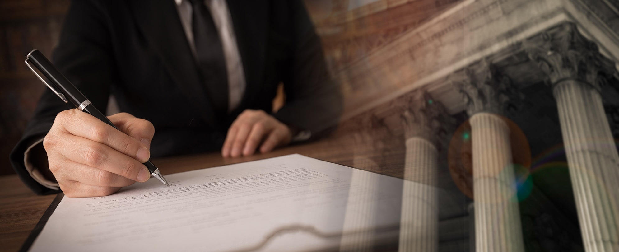 Man in suit writing on a document with fade-in of court building in background