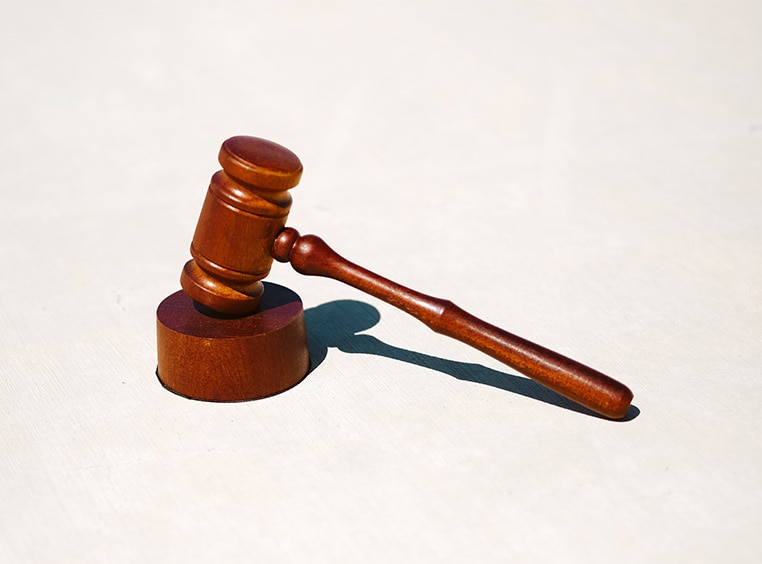 A wooden gavel resting on it's block. 