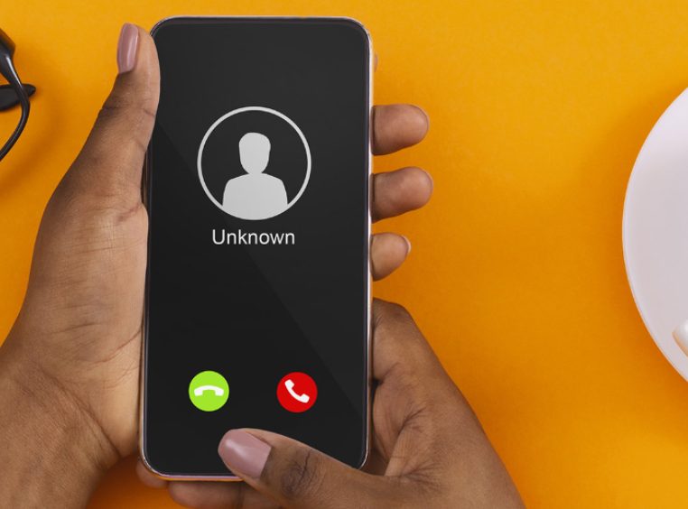 Close up of woman's hands with a smartphone and unknown incoming phone call on it
