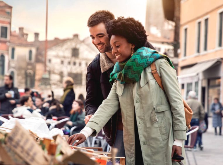 Couple exploring local markets on vacation 