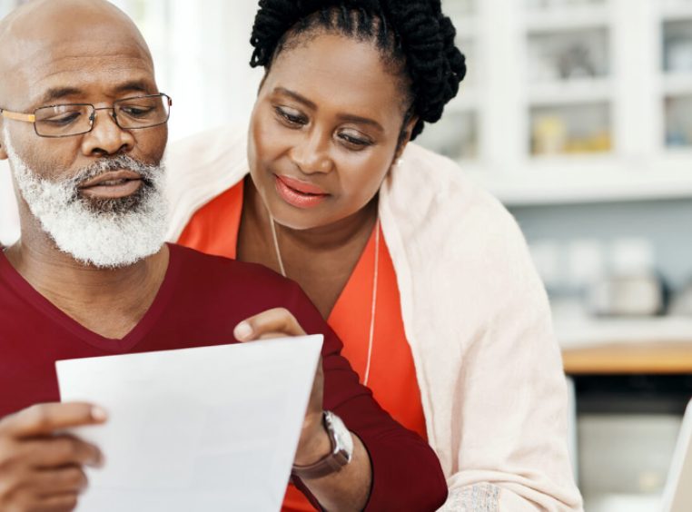 African American couple looking over important timeshare document 